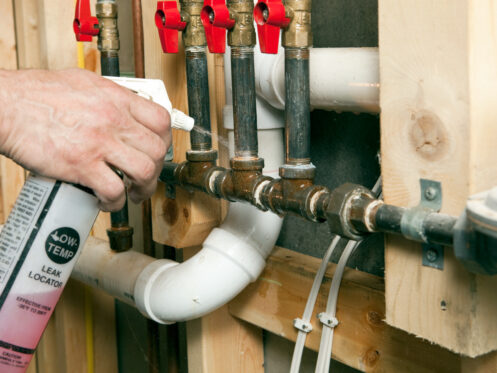 Plumber Using Leak Locator Spray on Gas Lines